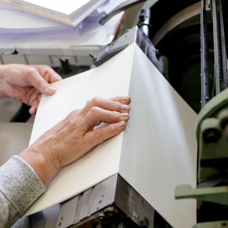 midsection-man-using-printing-press-machine